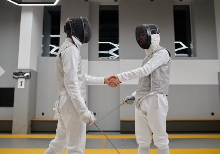 Professional fencers shaking hand after or before fencing match
